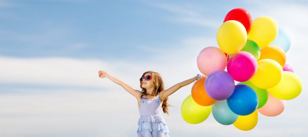 Child holding balloons